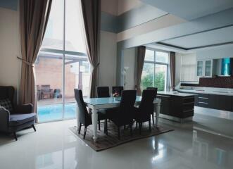 Spacious modern dining area with pool view