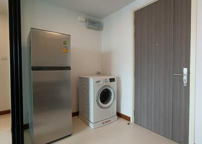 Utility room with a refrigerator and washing machine