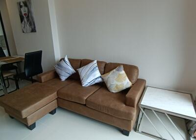 Living room with a brown sofa and side table
