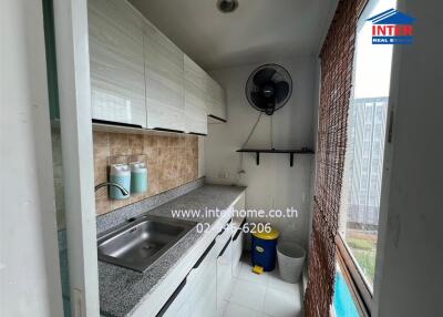 Compact kitchen space with modern amenities and exterior view