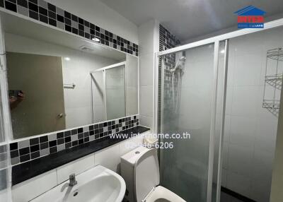 Modern bathroom with glass shower enclosure and large mirror