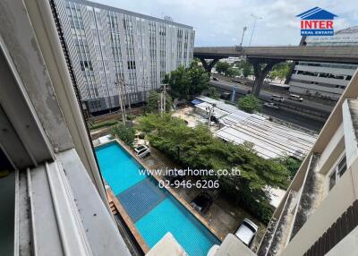 View of the swimming pool and adjacent building from a higher floor