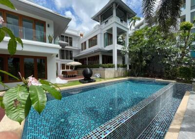 Luxury home with private swimming pool and lush landscaping