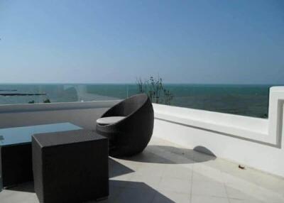 Outdoor terrace with ocean view, featuring modern outdoor furniture