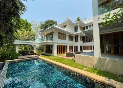 Exterior view of a multi-story house with a swimming pool