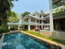 Exterior view of a multi-story house with a swimming pool