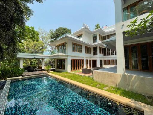 Exterior view of a multi-story house with a swimming pool