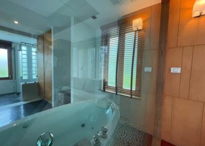 Modern bathroom with jacuzzi and glass shower enclosure