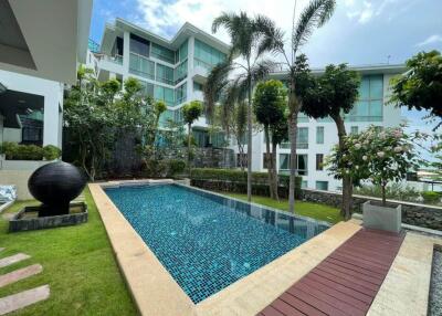 Modern building with outdoor pool and lush green surroundings