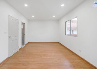 Empty room with wooden floor and white walls