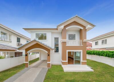 Front view of a modern two-story house with a driveway and front lawn