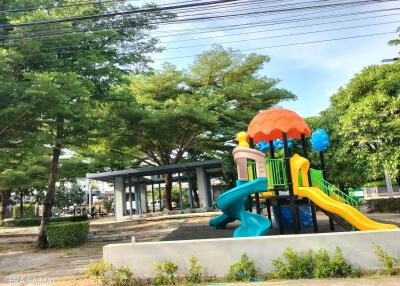 Colorful outdoor playground with slides and climbing structures in a park setting