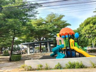 Colorful outdoor playground with slides and climbing structures in a park setting