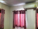 Bedroom with curtains and air conditioner