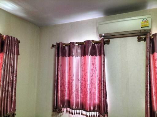 Bedroom with curtains and air conditioner