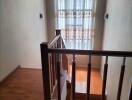 Interior stairwell with window and wooden flooring