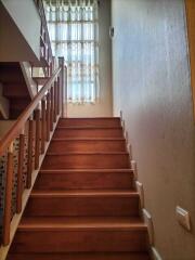 Indoor wooden staircase with handrail