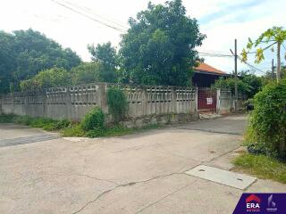 Front view of the property with perimeter wall and gate