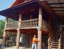 Elevated wooden house with balcony and staircase