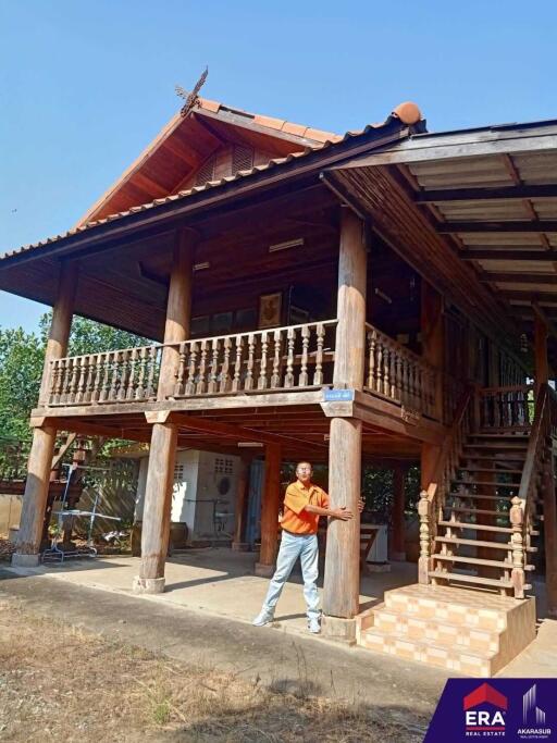 Elevated wooden house with balcony and staircase