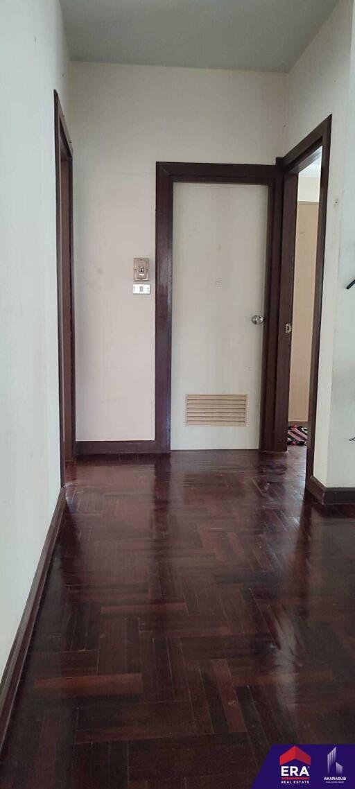 Hallway with dark wood flooring