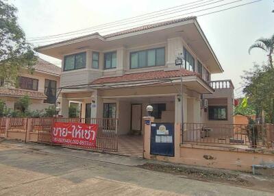 Two-story house with a front yard and a for sale sign