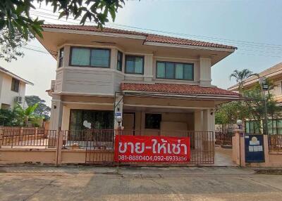 Front view of a two-story house with a sign in Thai language