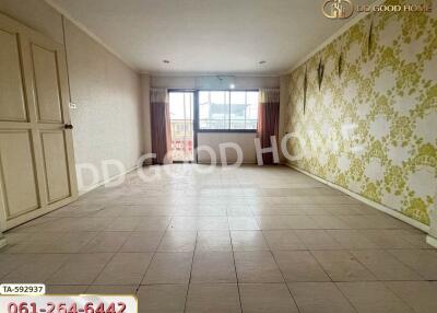 Spacious living room with tiled floors and large windows