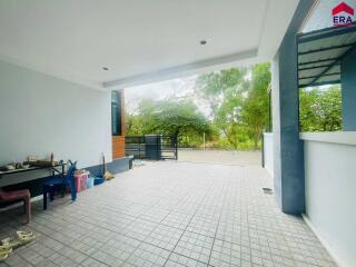 Minimalist outdoor area with tiled flooring and greenery view