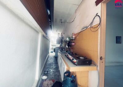 Narrow kitchen space with appliances and utensils