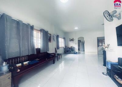 Spacious living room with white floor tiles and large windows