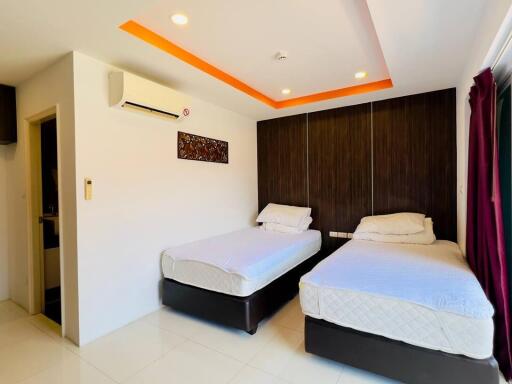 Bright bedroom with two single beds and modern decor