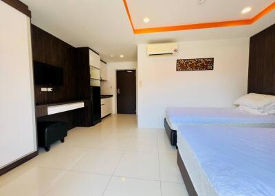 Modern bedroom with double beds, air conditioning, flat screen TV, and built-in furniture