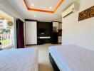 Modern bedroom with two beds, air conditioning, and balcony view