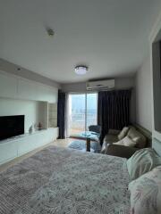 Bedroom with large bed, sofa, TV, and access to balcony