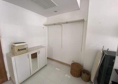 Laundry room with storage cabinet and hanging rod