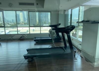Gym with treadmills and city view
