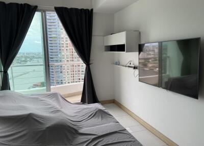 A bedroom featuring modern amenities and a balcony with a city view.