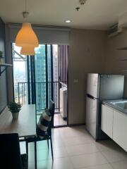 Modern kitchen with dining table and balcony view