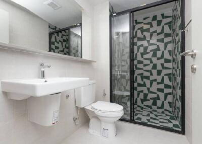 Modern bathroom with sink, toilet, and shower