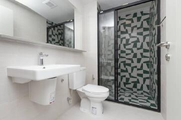 Modern bathroom with sink, toilet, and shower