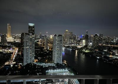 Nighttime city skyline view from balcony