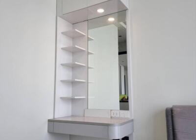 Bedroom with modern vanity area and storage shelves