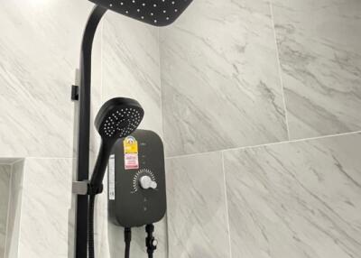 Modern shower area with dual showerheads and tile walls