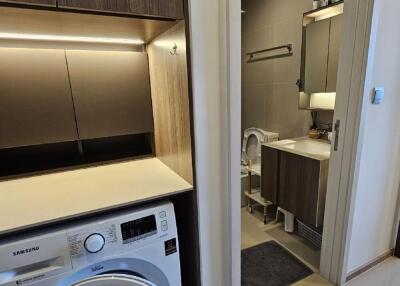 Bathroom with adjacent laundry area