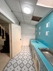 View of a blue-themed kitchen with tiled walls and flooring