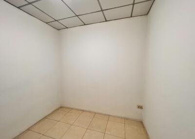 Empty room with tiled floor and drop ceiling