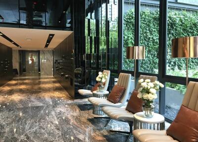 Elegant building lobby with modern seating and marble flooring