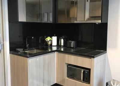 Modern kitchen with sleek black backsplash and stainless steel appliances