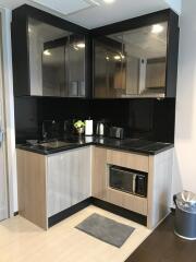 Modern kitchen with sleek black backsplash and stainless steel appliances